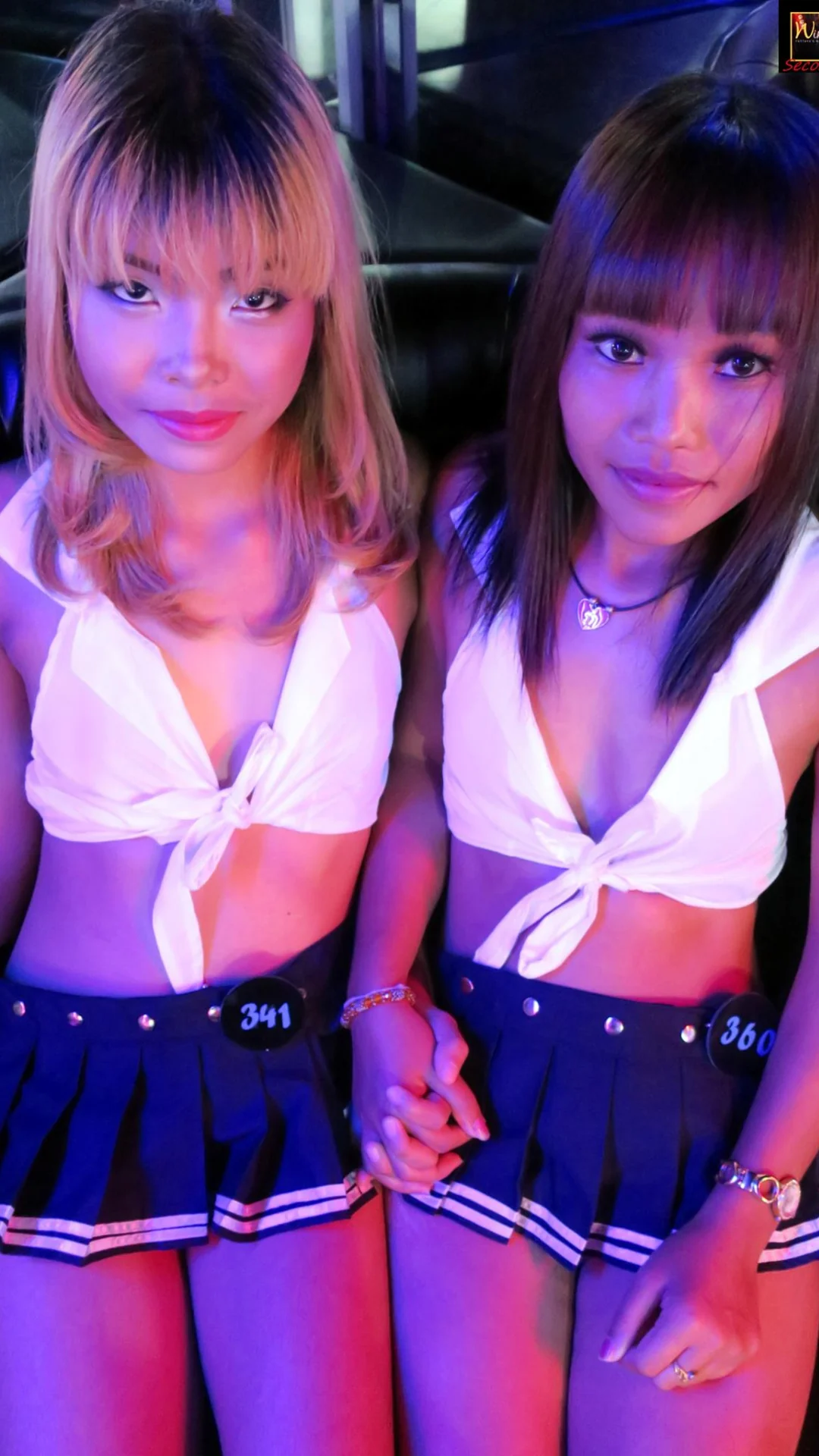 Two Windmill performers under purple lighting